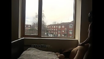 A slutty woman gets fucked by a black BBC by the window for public viewing pleasure